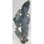 A Chinese carved jadeite figure of an Immortal with Dog of Fo at her side (mauve, green,