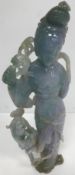 A Chinese carved jadeite figure of an Immortal with Dog of Fo at her side (mauve, green,