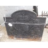 A cast iron fire back with Royal insignia inscribed 1635 50 cm high x 59 cm wide together with a