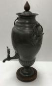 A 19th Century pewter samovar of Classical urn form with foliate decorated ring handles and tap,