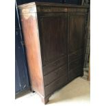 A 19th Century mahogany two door hanging cupboard as a linen press,