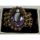 A filigree work amethyst set dress ring, the stone approx 1.2 cm x 0.