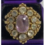 A Victorian yellow metal ring set with central oval cut amethyst, approx 2 carat, 1 cm x 0.