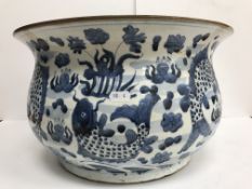 A large early 20th Century Japanese flared bowl with blue and white carp decoration,