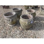 A pair of composite stone garden urns with Celtic knot style decoration 41 cm high together with a