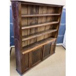 An oak bookcase cabinet with four open shelves over two cupboard doors 155 cm wide x 27 cm deep x