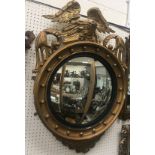 A Victorian giltwood and gesso framed wall mirror with spreadeagle and scrolling foliate surmount,