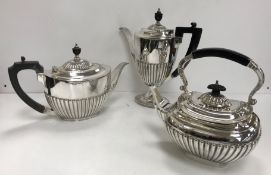 A plated tea pot and a plated coffee pot of oval form with reeded decoration and ebonised handles