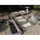 A collection of composite stone garden urns and troughs to include a pair of square urns on stepped