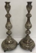 A pair of George V silver candlesticks of large proportions,