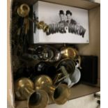 A box containing a collection of various modern brass ornaments including a pair of vases,