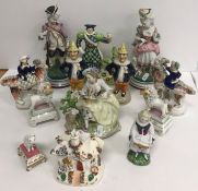 A collection of various china figures including two Mr Punch pottery peppers, 16 cm high,