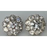 A pair of unmarked white metal mounted diamond cluster flower head design ear studs,