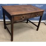 A circa 1900 oak two drawer side table on square moulded supports united by stretchers in the