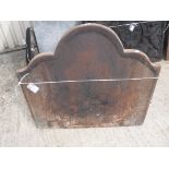 A cast iron fire back of flame form 68 cm high x 77 cm wide together with a pair of wrought iron