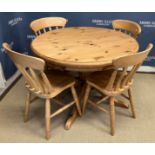 A modern pine breakfast table, the circular top on a turned pedestal to cabriole quadruped base,