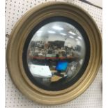 A Victorian giltwood and gesso framed convex wall mirror with ebonised reeded slip,