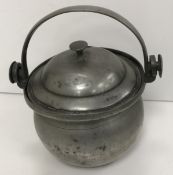 A pewter lidded tankard with scrollwork thumb piece and handle,