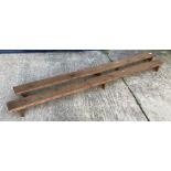 A pair of vintage pine church or chapel kneelers with single plank top on trestle supports 198.