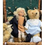 A modern picnic basket (fittings missing) containing a circa 1930s doll with plastic head and