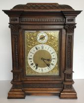 A circa 1900 German carved oak cased mantel clock,