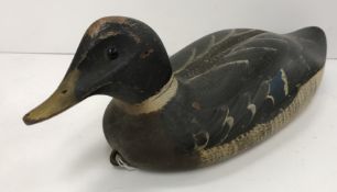 A 19th Century painted wooden decoy duck with iron loop fixing to breast 35.