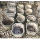 A collection of eleven composite stone urns to include a set of four circular urns with oak leaf