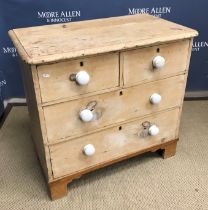 A Victorian pine chest of two short over two long drawers with pottery handles, on bracket feet,