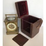 A large carriage style clock, the top with swing handle and silvered dial,