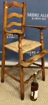A 19th Century child's ash rush seat ladder back high chair on turned legs united by stretchers, 40.