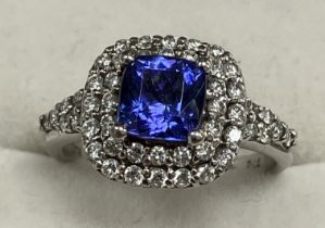 An 18 carat white gold tanzanite and diamond set dress ring size K together with Ankhor Cert.