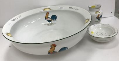 A "Chanticler" pattern toilet bowl with toothbrush holder and soap dish decorated with a crowing