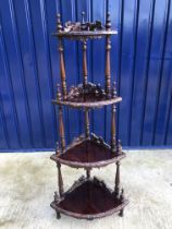 A reproduction mahogany four tier corner whatnot in the Victorian taste, 60 cm wide x 148 cm high,