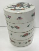 A circa 1900 Chinese porcelain stacking box of four sections in cylindrical form,