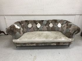 A modern patchwork buttoned upholstered Chesterfield type sofa on silvered turned and reeded feet