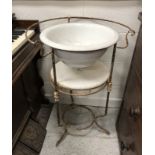 A vintage French iron framed washstand with circular ceramic bowl, over an alabaster undertier,