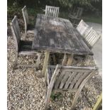 A teak garden table 97 cm x 190 cm x 75 cm high and six chairs 95 cm high bearing John Lewis labels