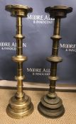 A large pair of brass ecclesiastical style altar type candlesticks with castellated drip trays on