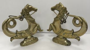 A pair of 19th Century Venetian brass hippocamp gondola ornaments on oval bases,