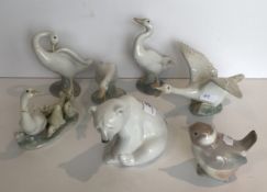 A collection of seven Lladro figures including seating polar bear, wren,
