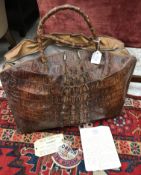 A vintage crocodile skin bag with twin handles,