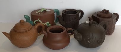 A collection of six Yi Xing tea pots, five with various seal marks,