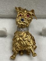 An 18 carat gold Scottie dog with diamond encrusted collar, sapphire nose and ruby eyes 3.