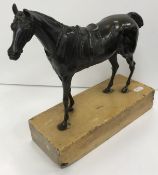 A chocolate patinated bronze figure of a "Racehorse, saddled", raised on a plain siena marble base,