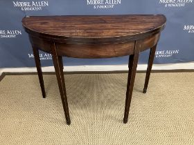 An early 19th Century mahogany demi-lune fold-over tea table on square tapered legs, 98.