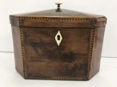 An early 19th Century yew wood and inlaid elongated octagonal tea caddy,