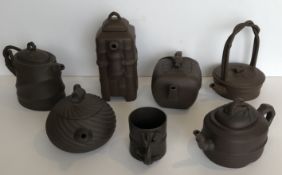 A collection of six Chinese Yi Xing tea pots various with various seal marks together with a Yi