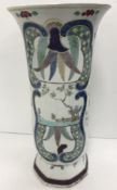 An 18th Century Chinese polychrome decorated vase with flared rim on a hexagonal foot,