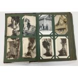 An early 20th Century leather covered postcard album and contents of various postcards including
