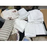 Two boxes of assorted bed linen including linen sheets, three cushions of various designs,